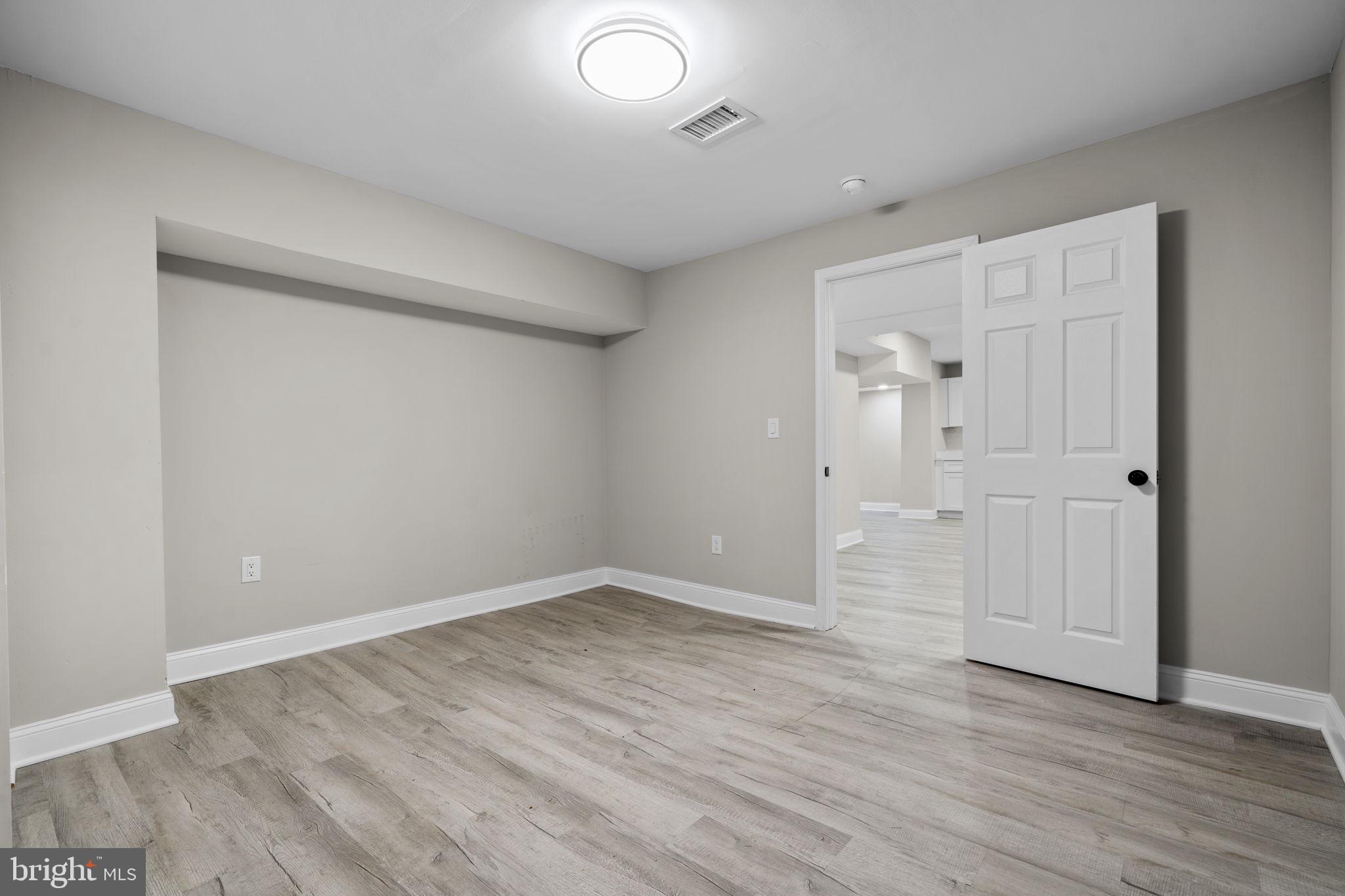 1501 Pine Grove Road Capitol Heights, MD 20743 - Photo 35 of 44 a view of an empty room with wooden floor