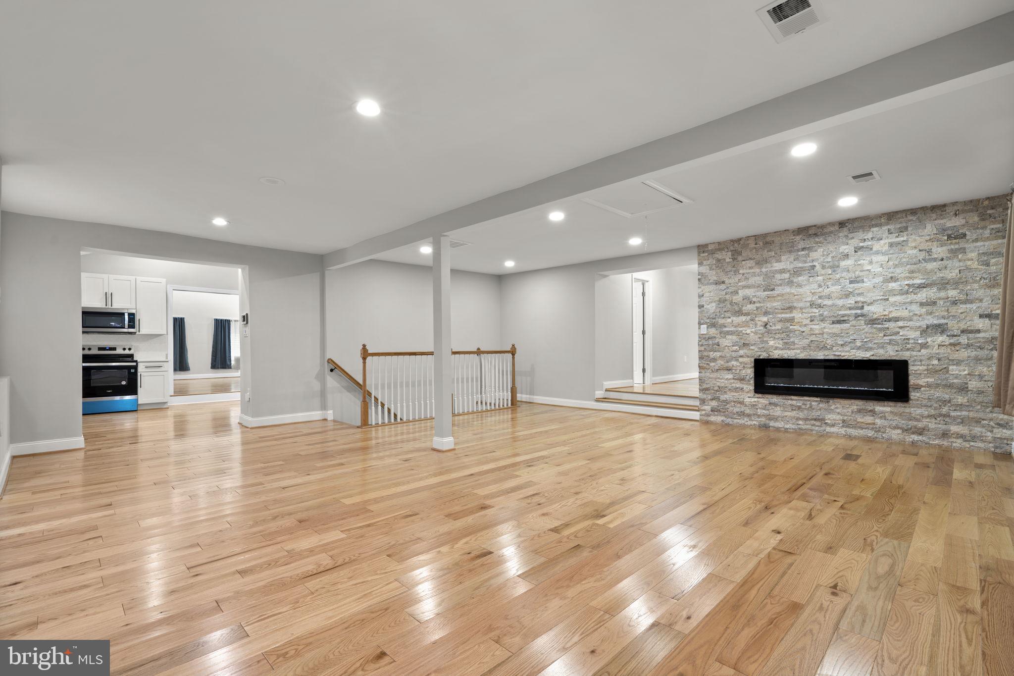 1501 Pine Grove Road Capitol Heights, MD 20743 - Photo 4 of 44 a view of empty room with wooden floor and fireplace