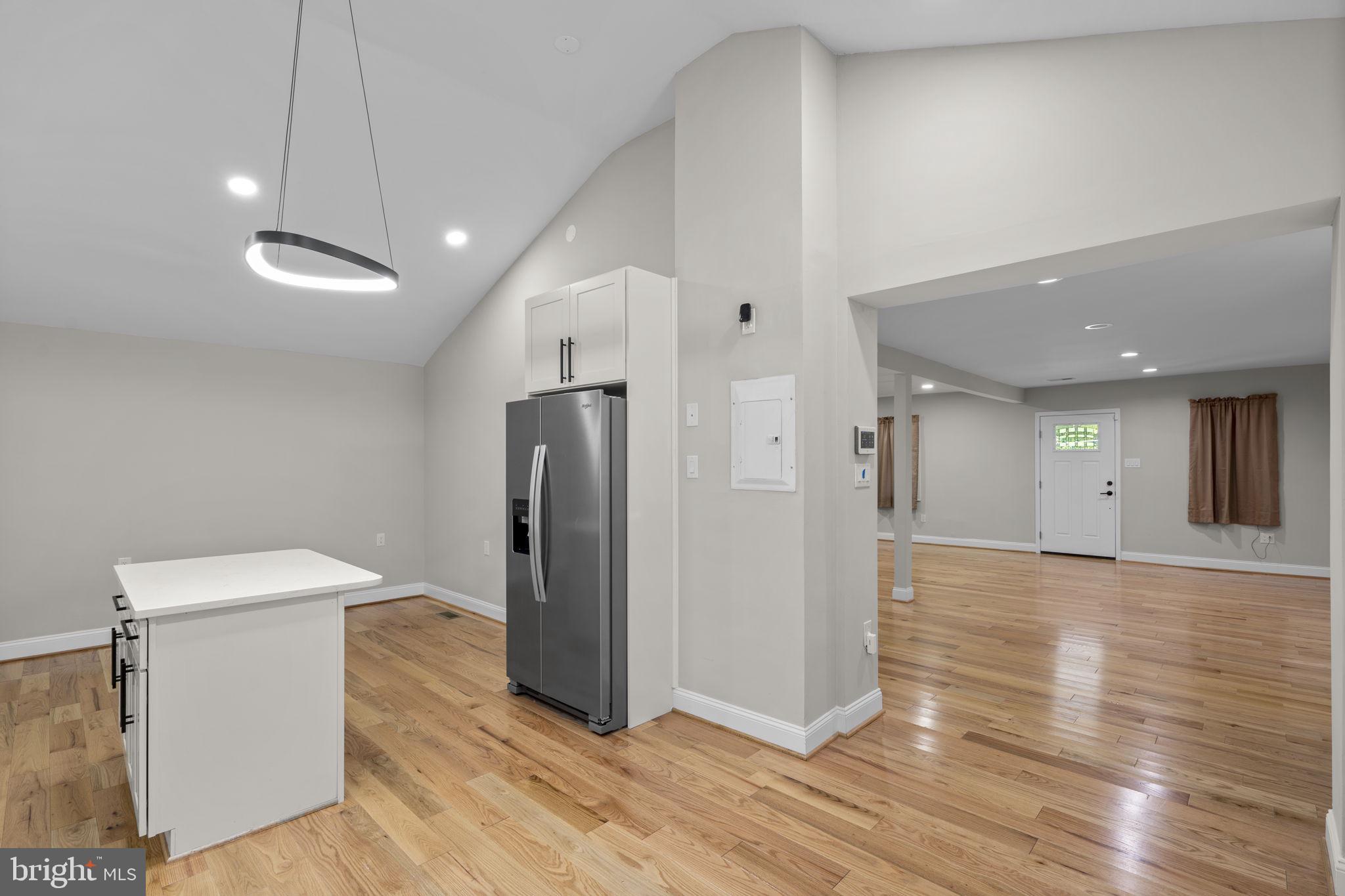 1501 Pine Grove Road Capitol Heights, MD 20743 - Photo 6 of 44 a view of a hallway with wooden floor and a refrigerator