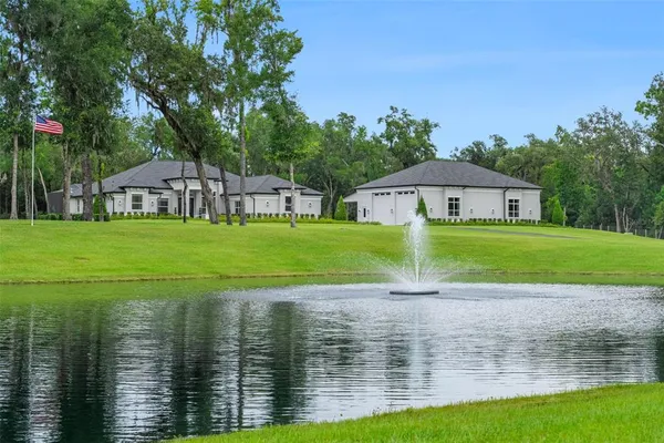 a view of a lake with a house in the background
