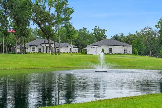 a view of a lake with a house in the background