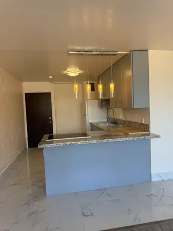 a view of a kitchen with a sink and cabinets