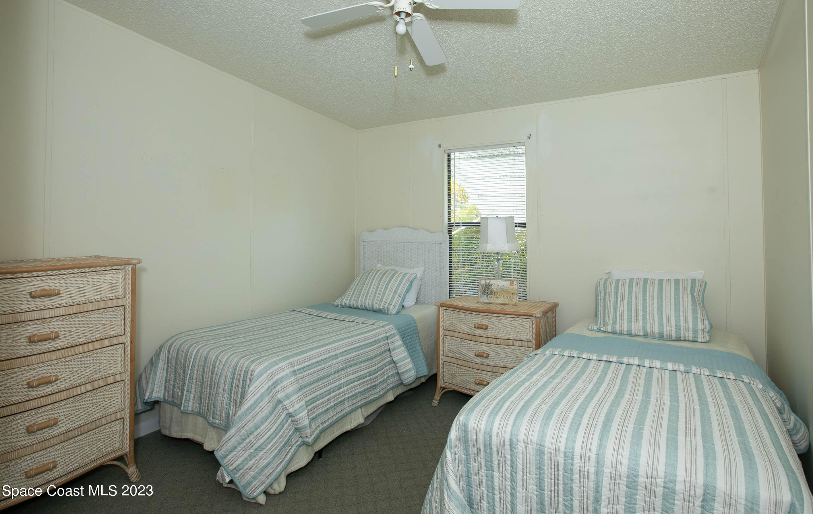 6183 97th Street Sebastian, FL 32958 - Photo 13 of 18 a bedroom with two beds and large window