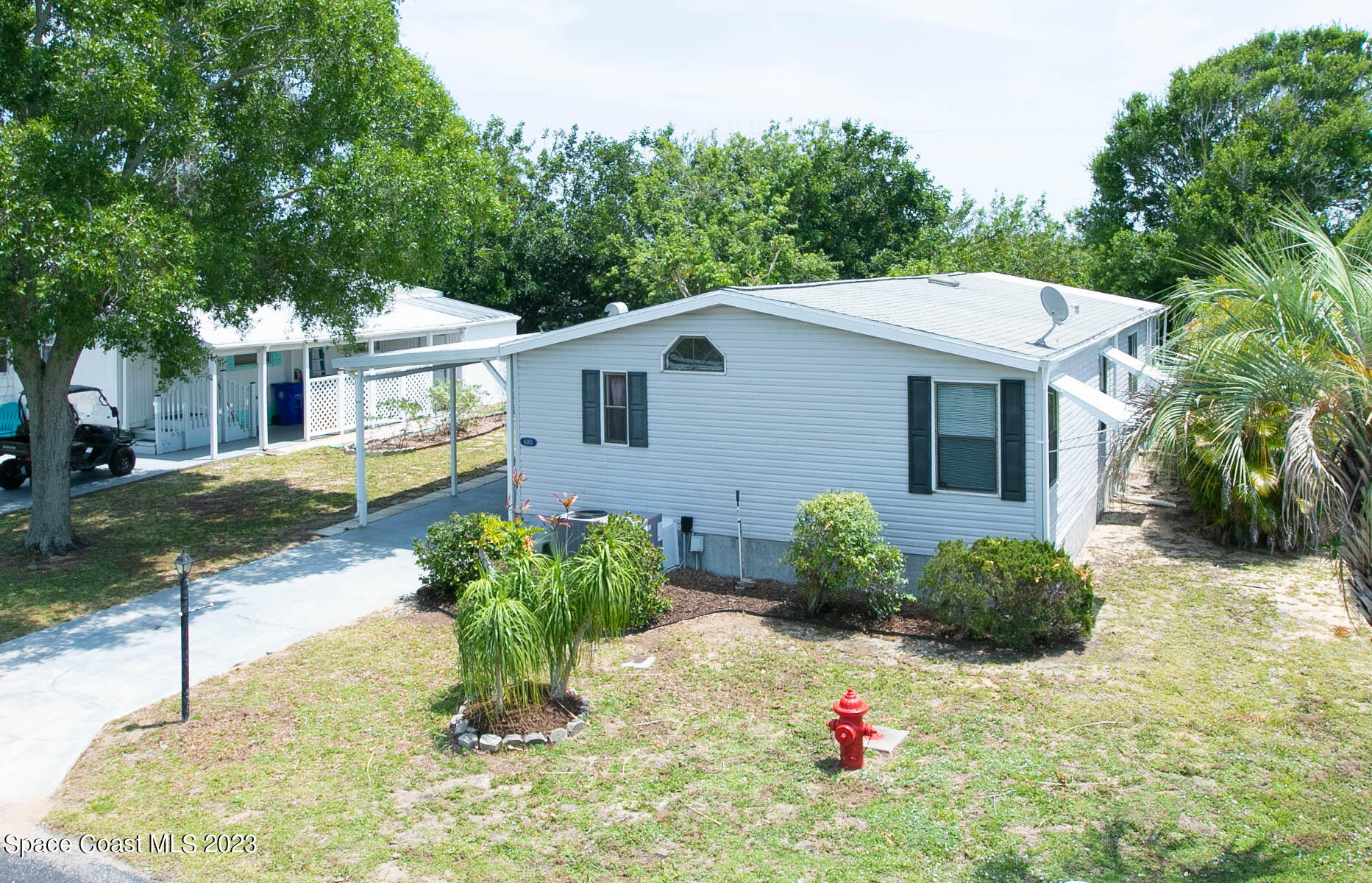 6183 97th Street Sebastian, FL 32958 - Photo 2 of 18 a view of a house with a yard and potted plants