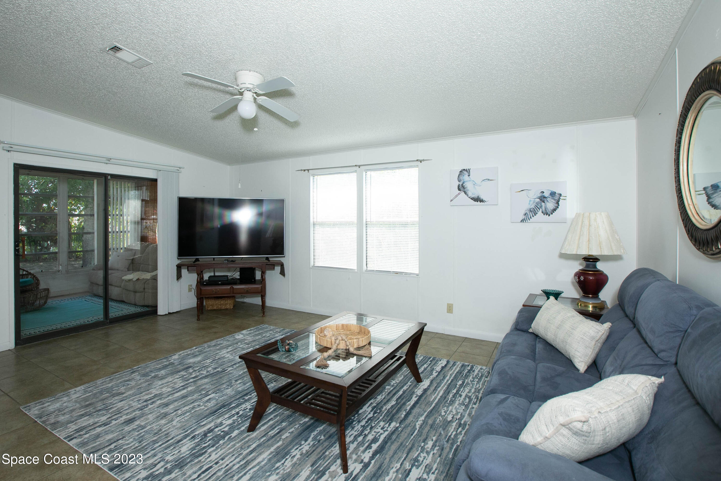 6183 97th Street Sebastian, FL 32958 - Photo 4 of 18 a living room with furniture and a flat screen tv