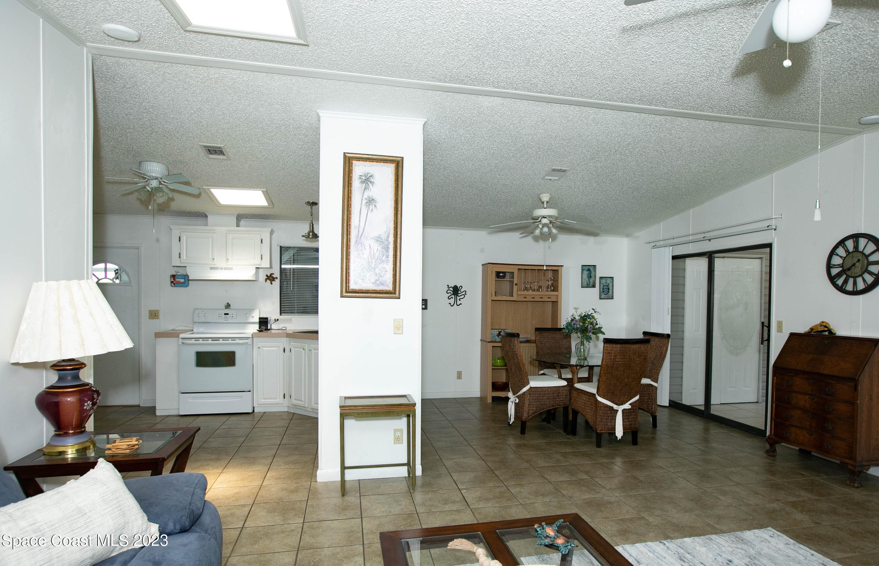 6183 97th Street Sebastian, FL 32958 - Photo 6 of 18 a living room with furniture and a chandelier