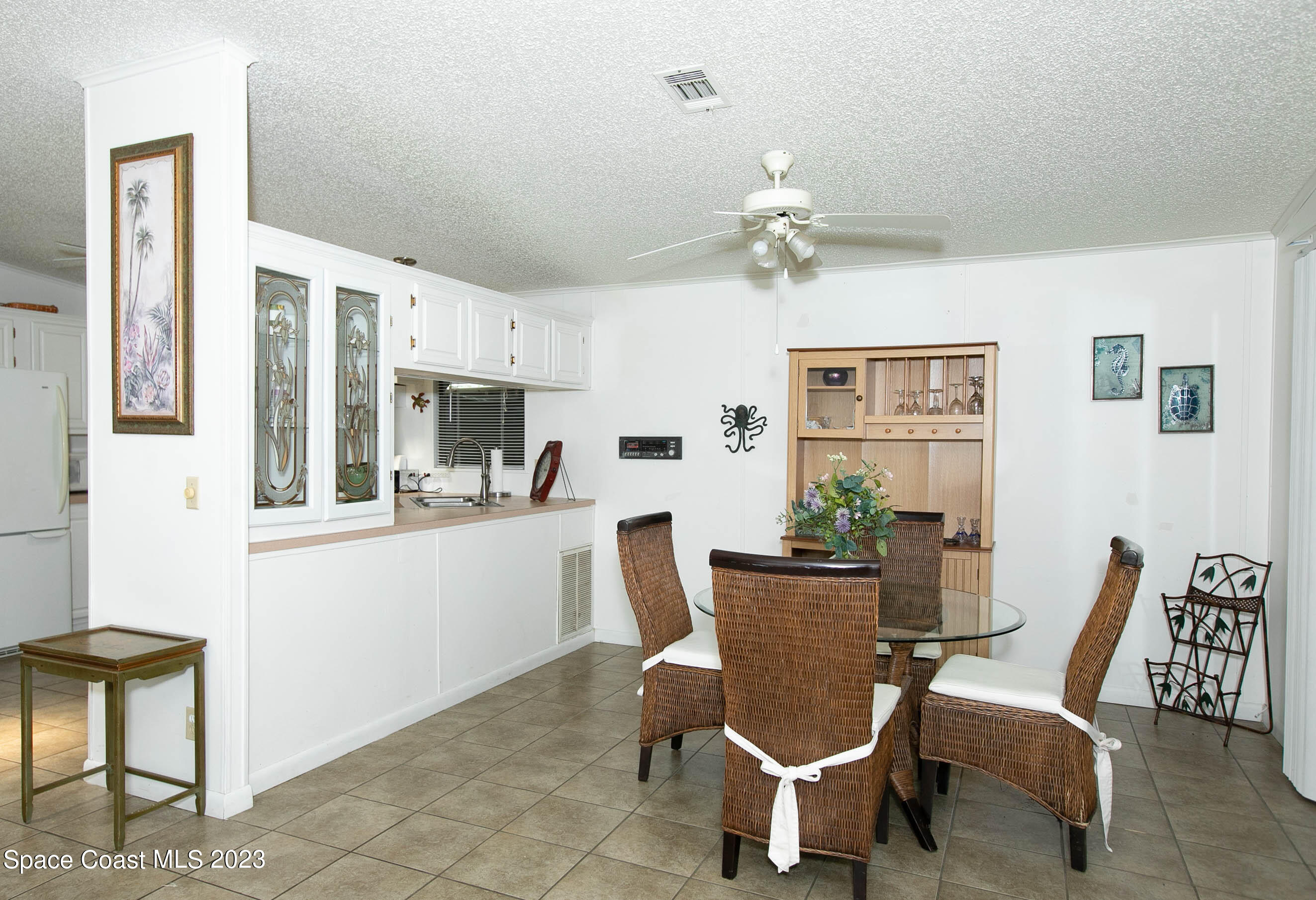 6183 97th Street Sebastian, FL 32958 - Photo 7 of 18 a dining room with furniture a chandelier and window