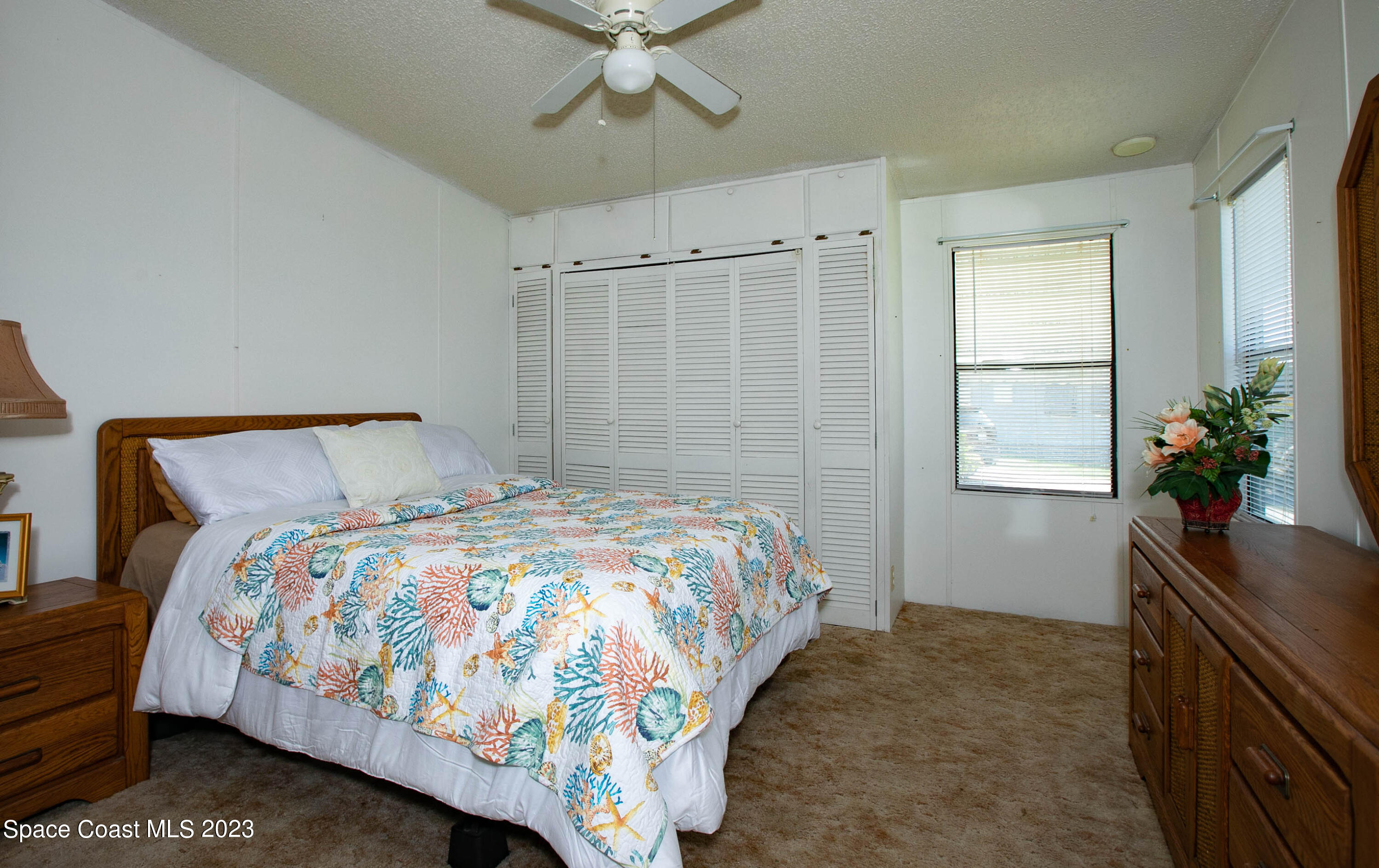 6183 97th Street Sebastian, FL 32958 - Photo 10 of 18 a bedroom with a bed and a potted plant