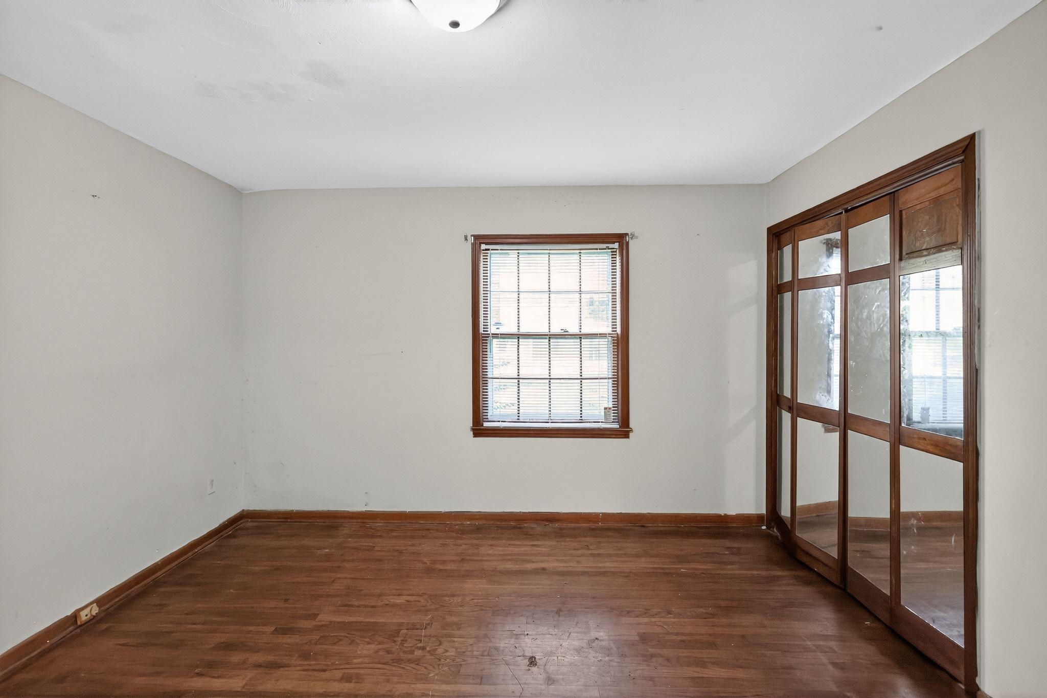 4905 Lochinvar Road Memphis, TN 38116 - Photo 15 of 33 a view of an empty room with wooden floor and a window