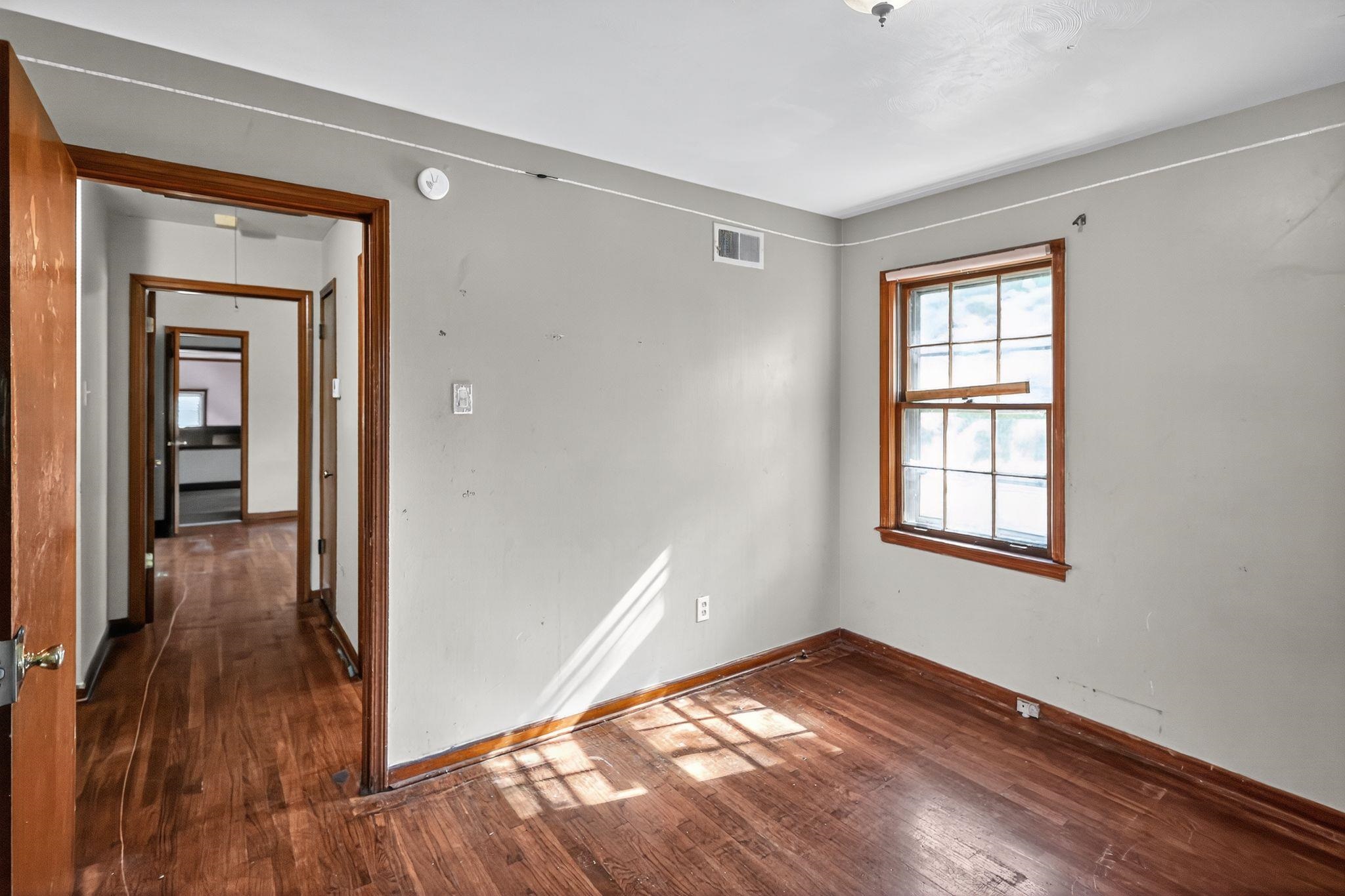4905 Lochinvar Road Memphis, TN 38116 - Photo 18 of 33 a view of empty room with wooden floor and fan