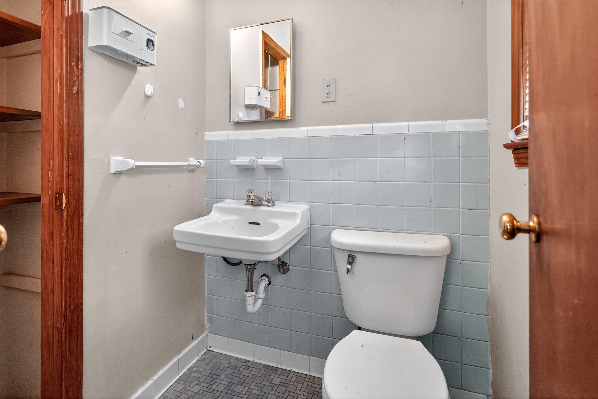 4905 Lochinvar Road Memphis, TN 38116 - Photo 20 of 33 a bathroom with a toilet sink and mirror