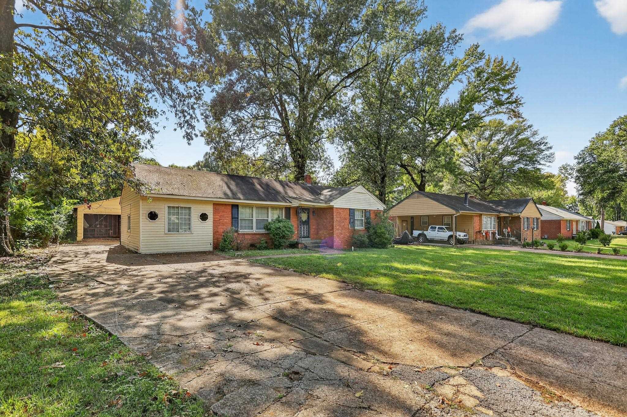 4905 Lochinvar Road Memphis, TN 38116 - Photo 28 of 33 a front view of a house with a garden and trees