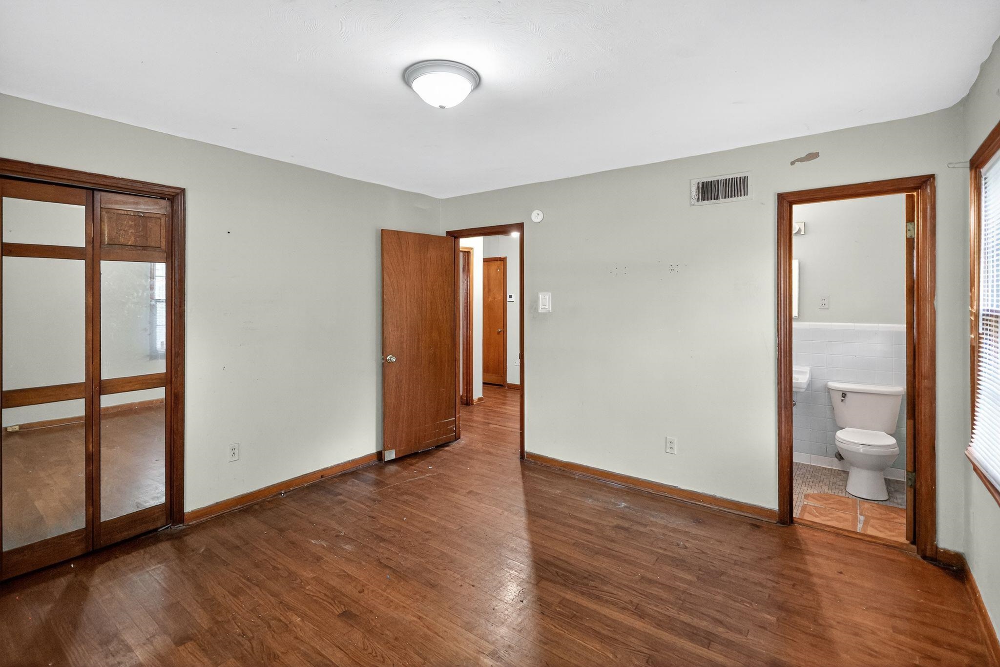 4905 Lochinvar Road Memphis, TN 38116 - Photo 3 of 33 an empty room with wooden floor and windows