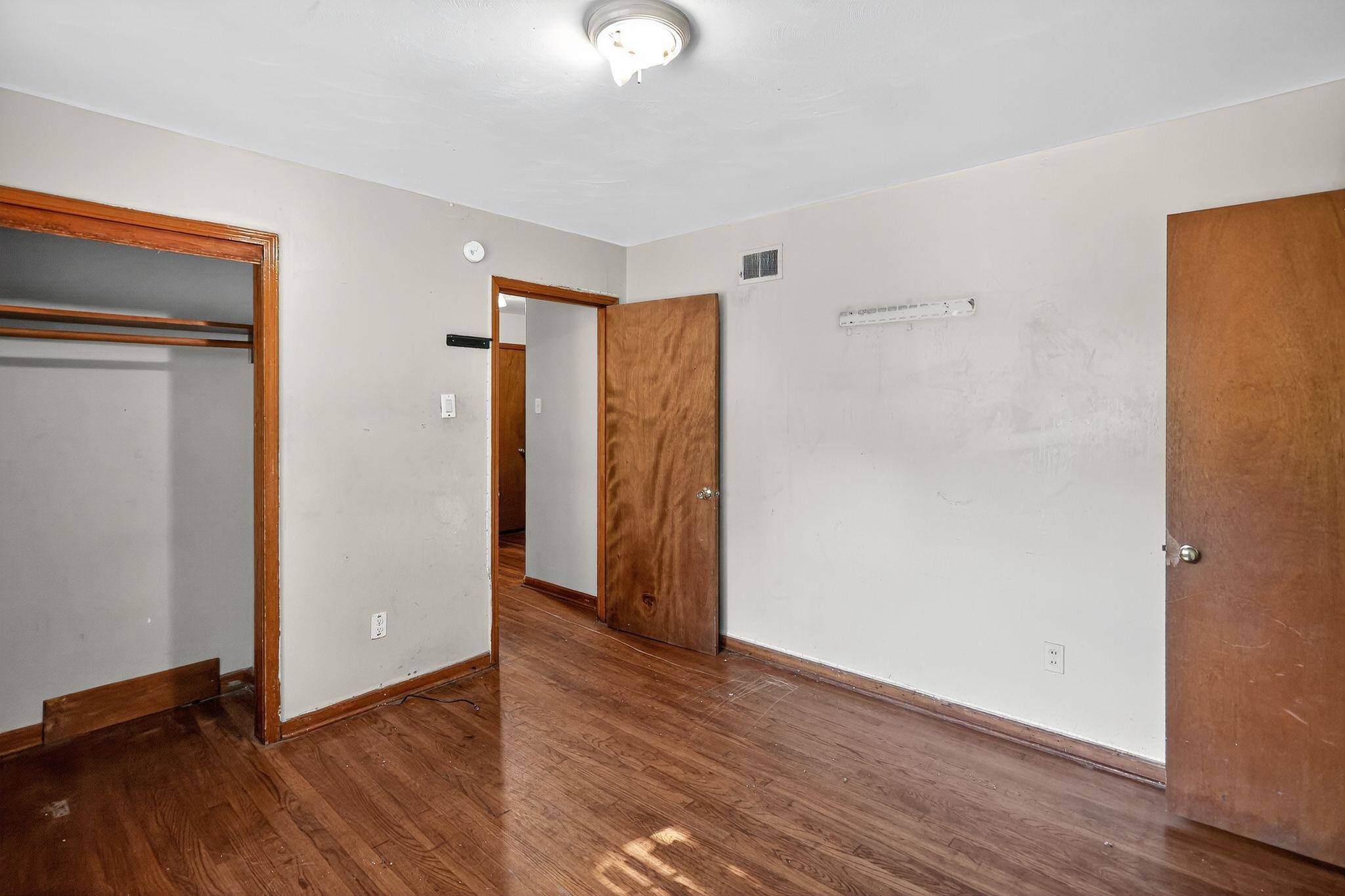 4905 Lochinvar Road Memphis, TN 38116 - Photo 9 of 33 a view of an empty room with wooden floor and closet