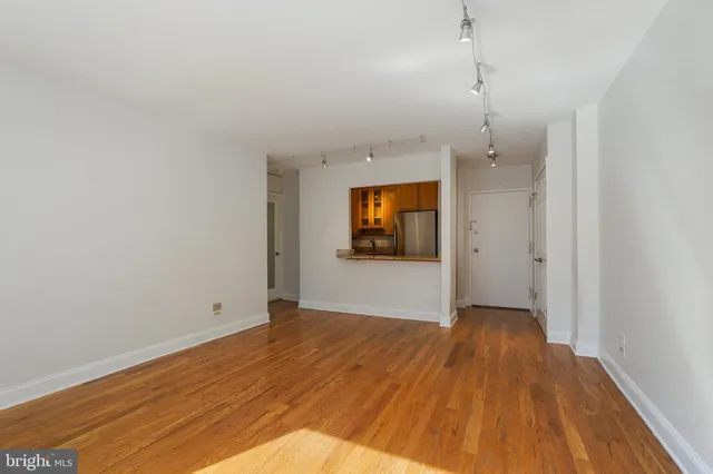 a view of an empty room and wooden floor