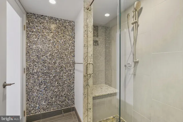 a bathroom with a glass shower door
