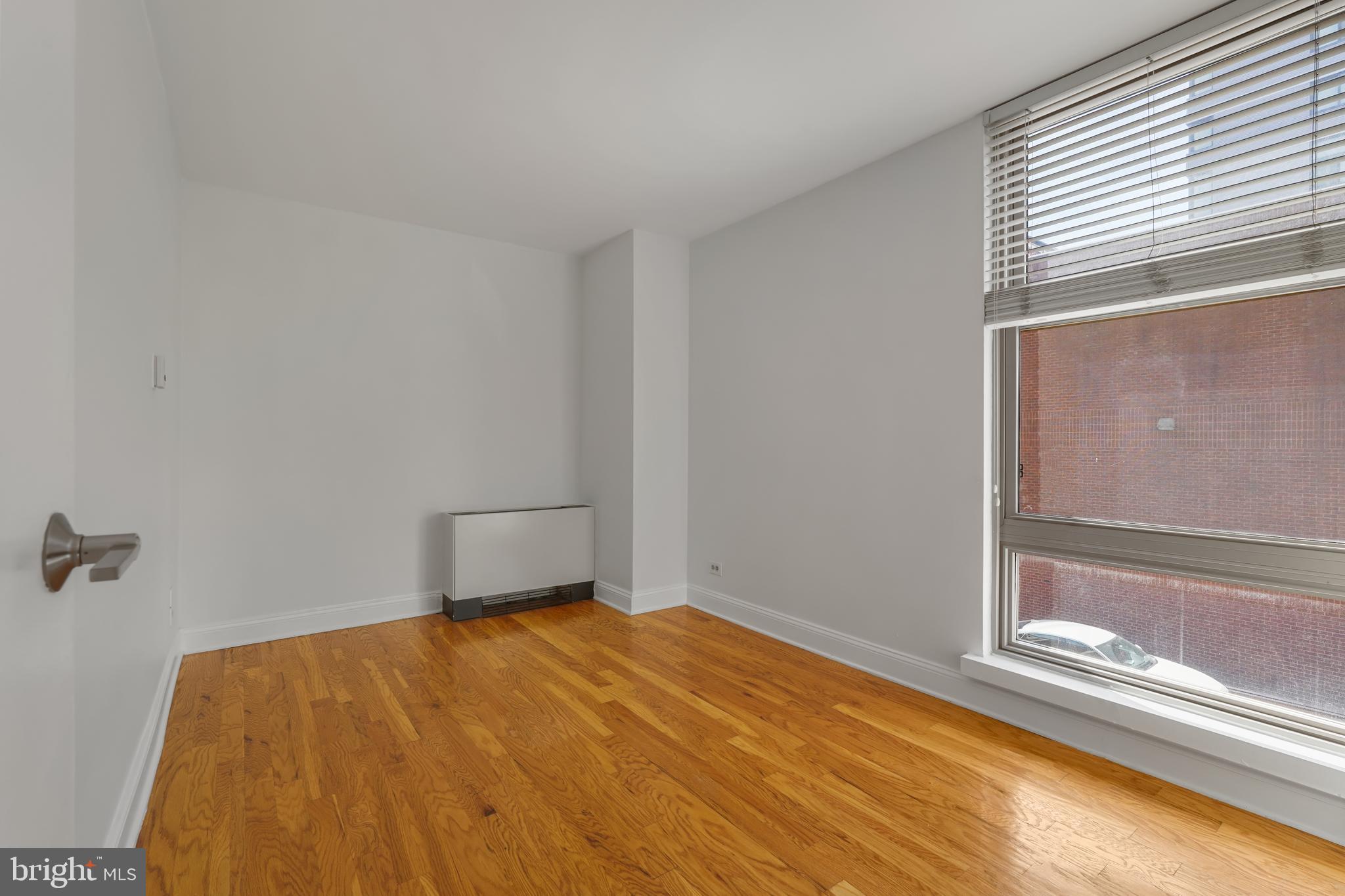 1260 21st Street Northwest, Unit 306 Washington, DC 20036 - Photo 19 of 23 a bedroom with a bed and a window
