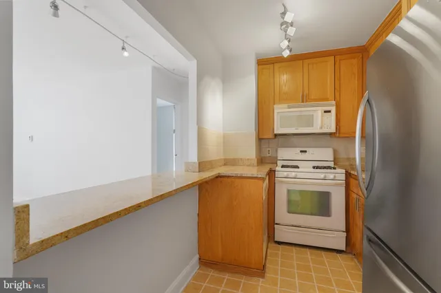 a kitchen with stainless steel appliances a stove a microwave and a refrigerator