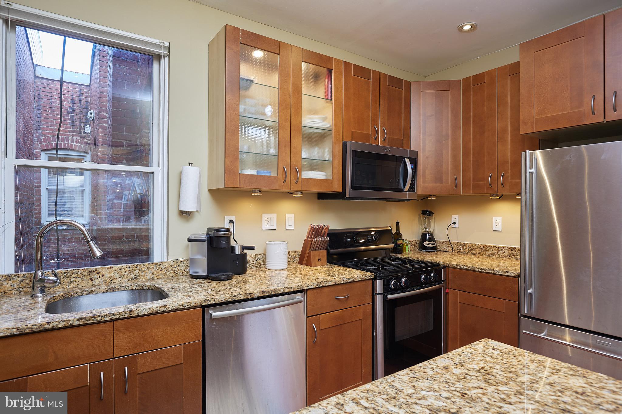 1745 T Street Northwest Washington, DC 20009 - Photo 21 of 35 a kitchen with granite countertop a stove a sink and a refrigerator