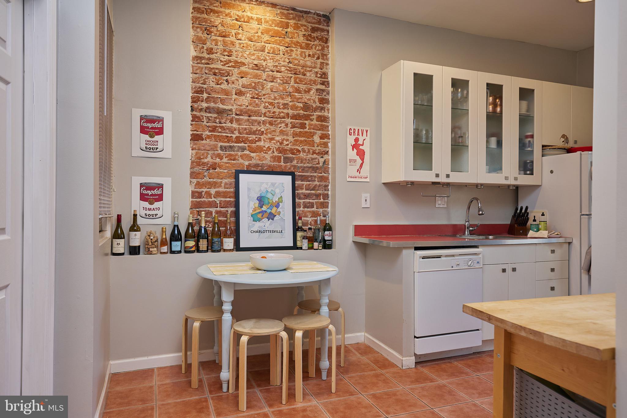 1745 T Street Northwest Washington, DC 20009 - Photo 6 of 35 a kitchen with a dining table chairs and white appliances