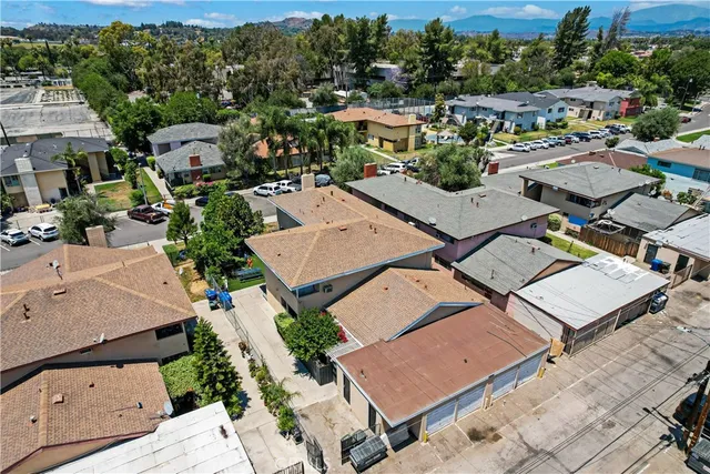 an aerial view of a residential houses with outdoor space and street view
