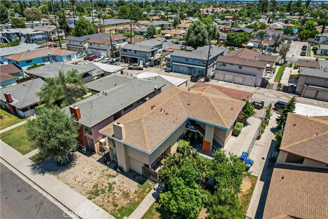 an aerial view of a house with a yard basket ball court and outdoor seating