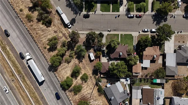 an aerial view of multiple houses with yard