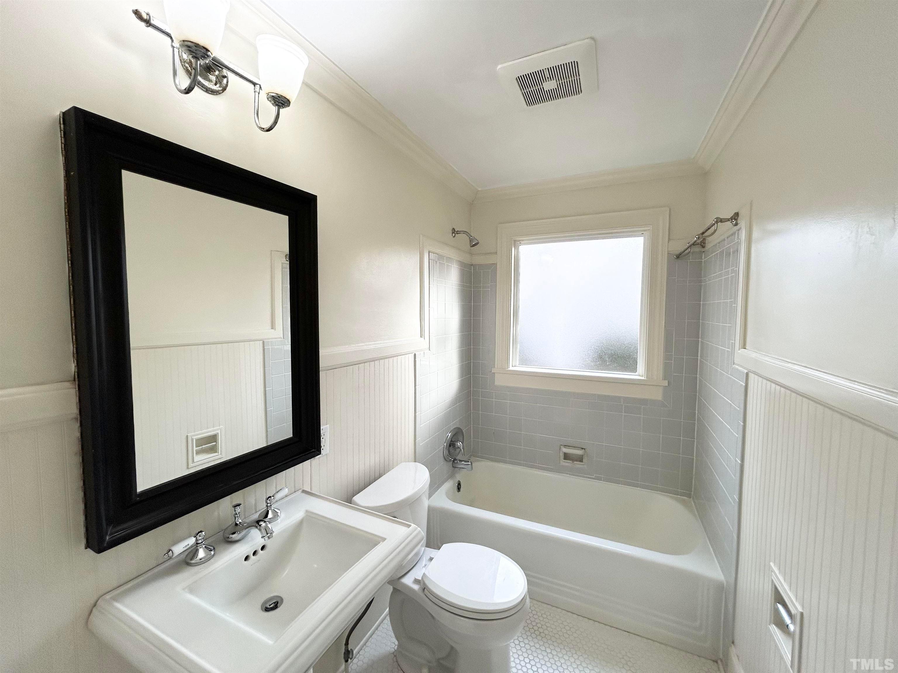 1607 Carson Street Raleigh, NC 27608 - Photo 11 of 17 a bathroom with a bathtub shower sink vanity mirror and toilet