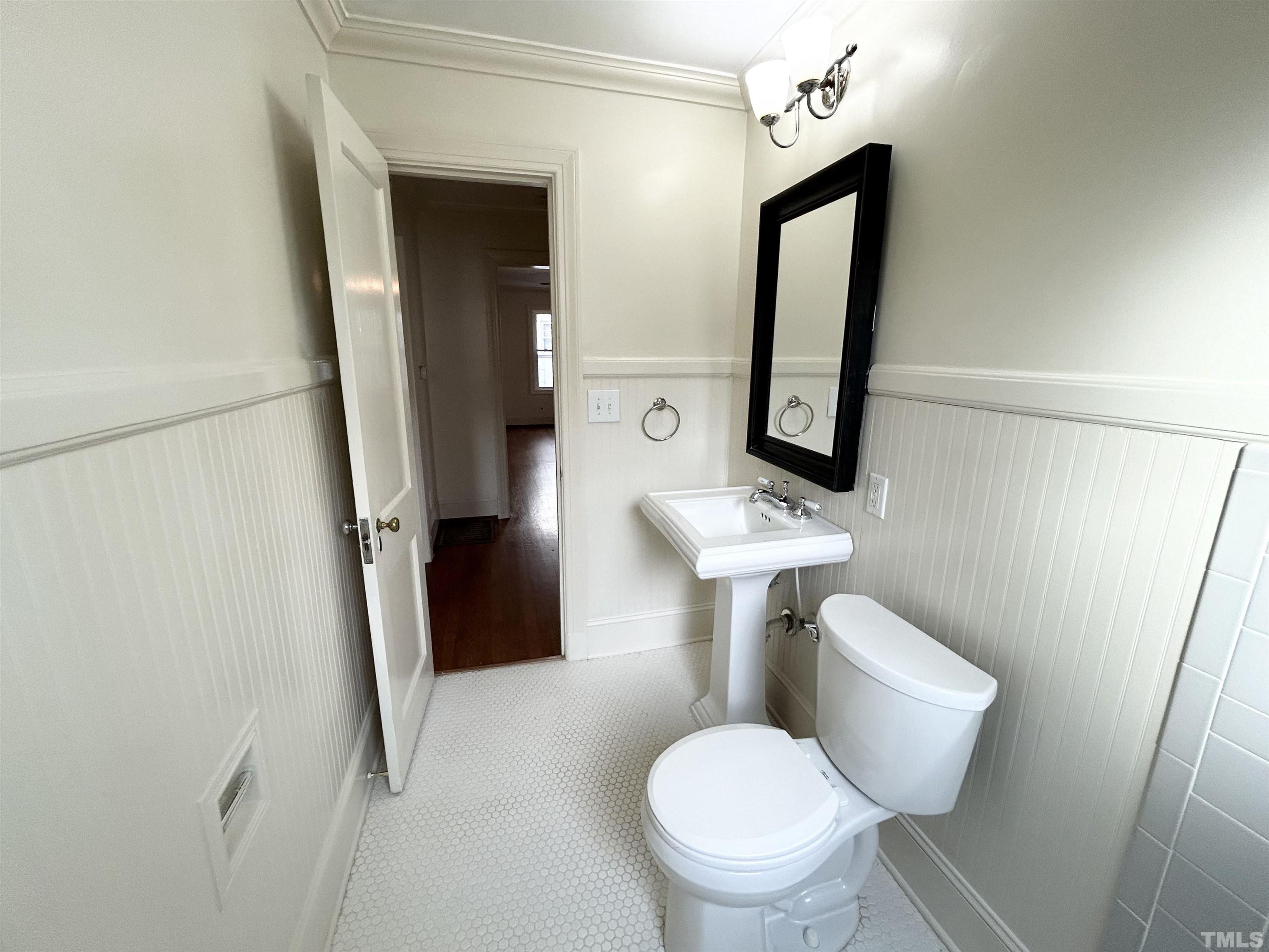 1607 Carson Street Raleigh, NC 27608 - Photo 12 of 17 a bathroom with a toilet sink and mirror