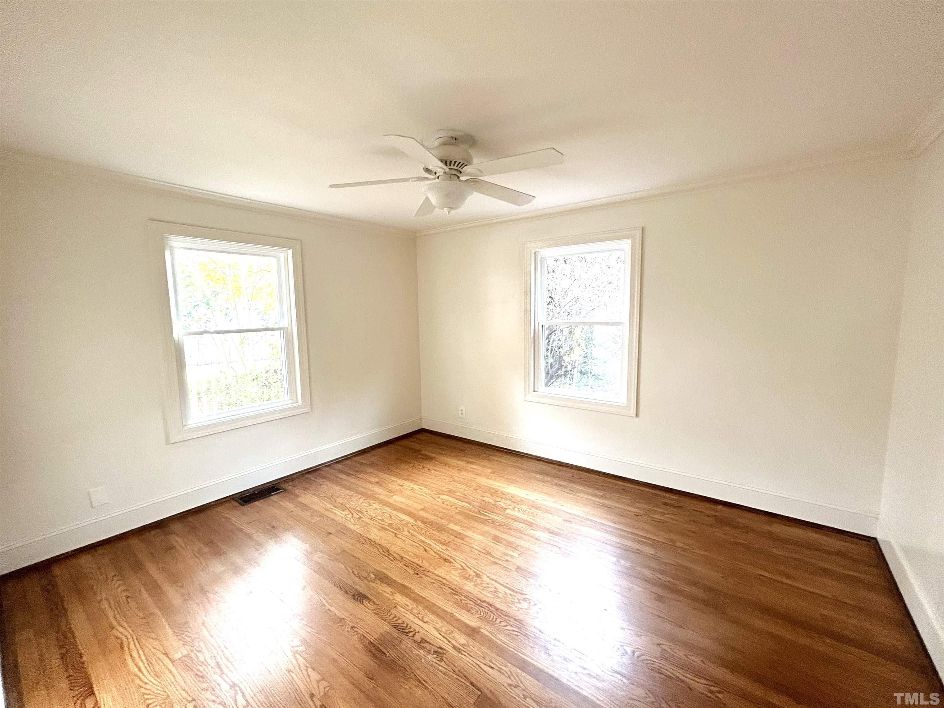 1607 Carson Street Raleigh, NC 27608 - Photo 13 of 17 a view of an empty room with wooden floor and a window