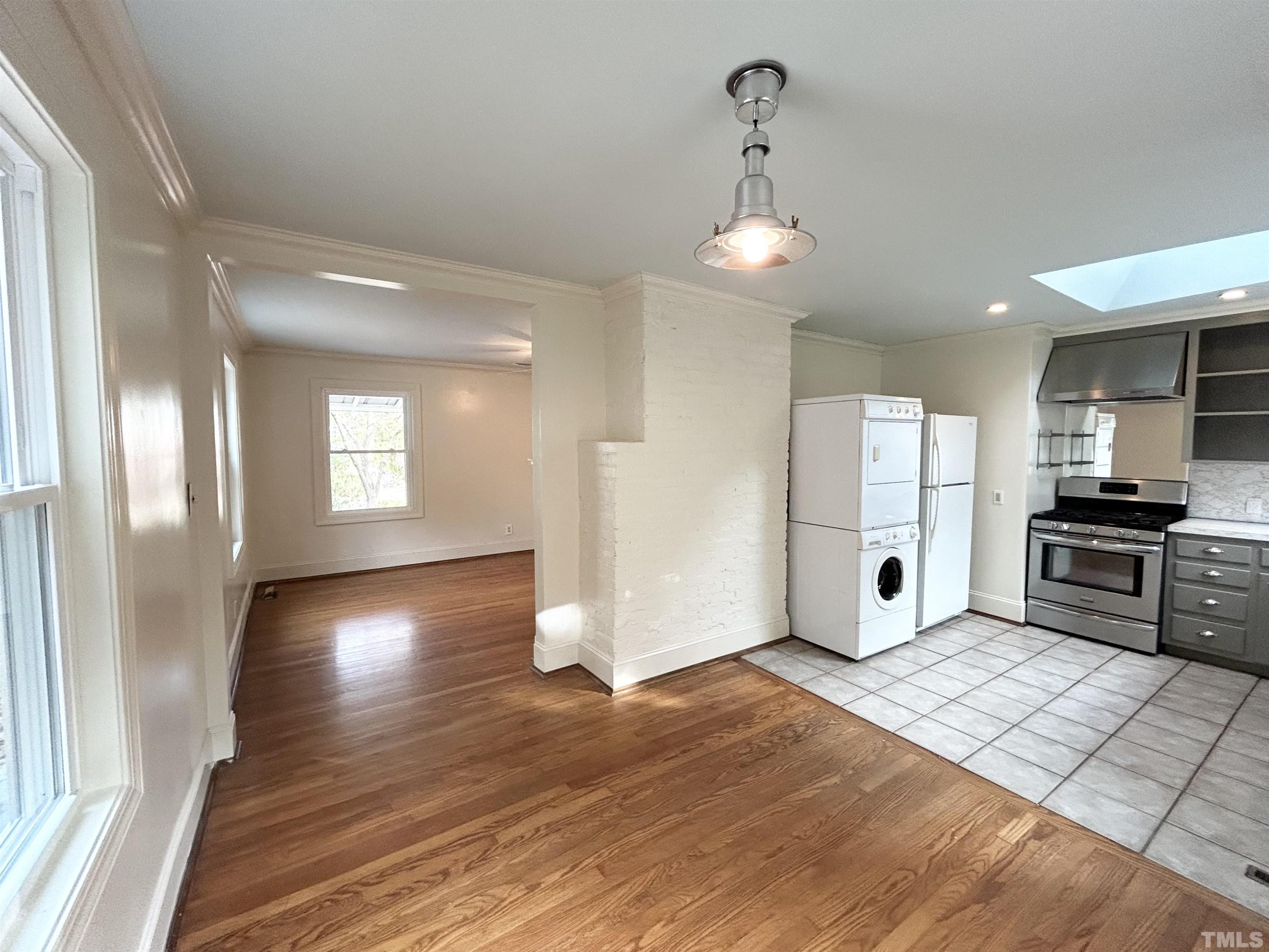 1607 Carson Street Raleigh, NC 27608 - Photo 4 of 17 a view of a kitchen with refrigerator and wooden floor