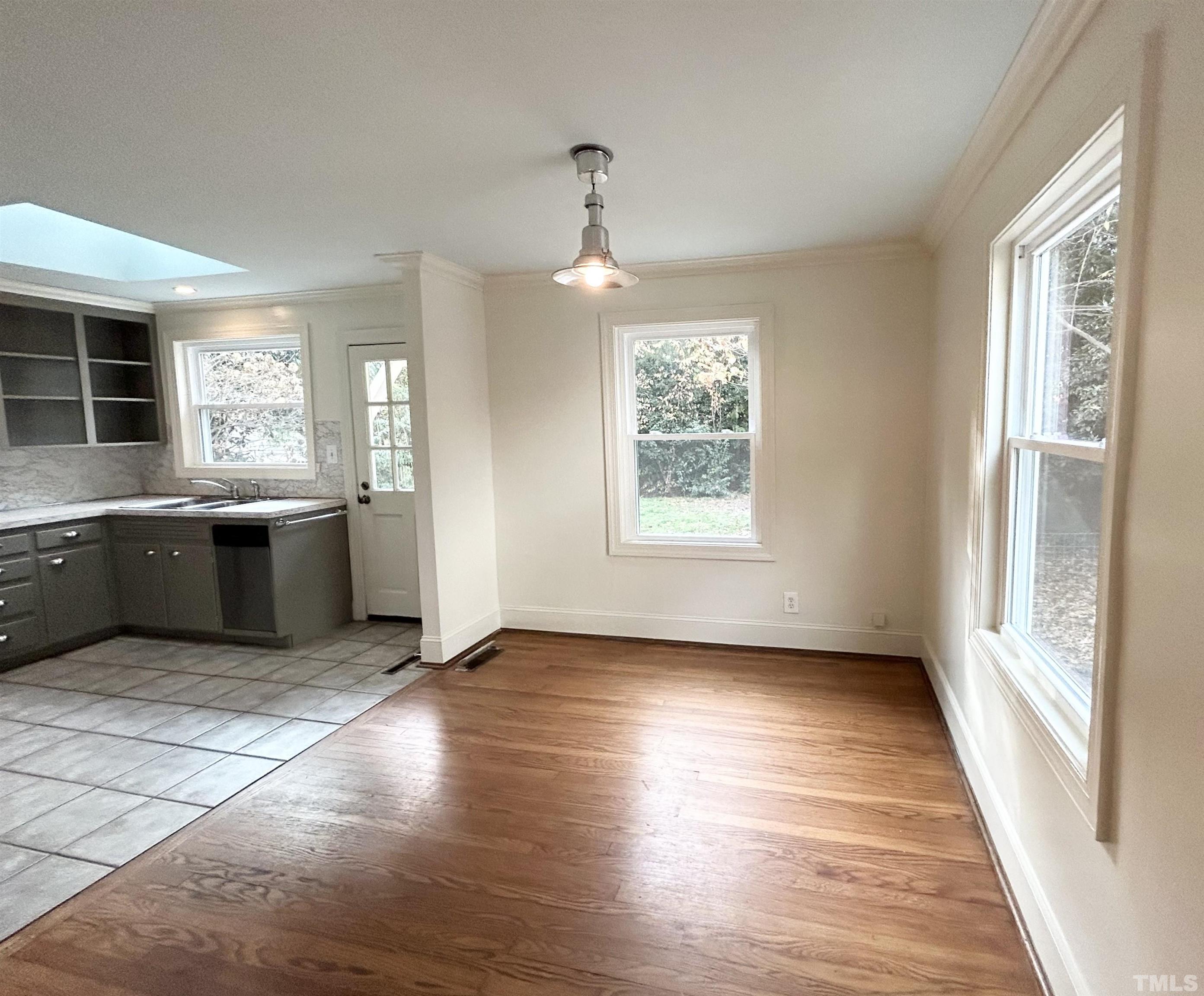 1607 Carson Street Raleigh, NC 27608 - Photo 5 of 17 a view of a kitchen with wooden floor and a window