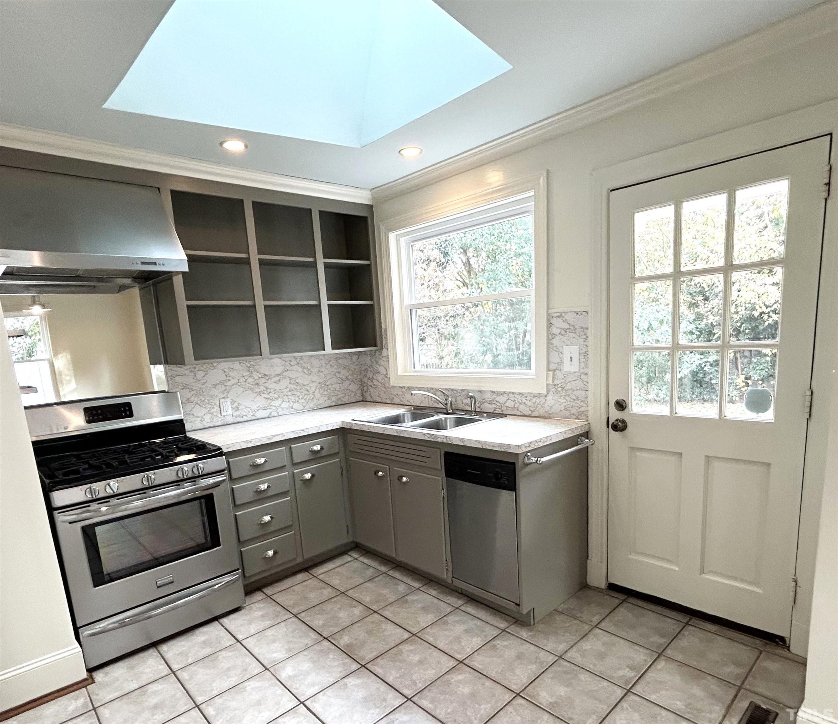 1607 Carson Street Raleigh, NC 27608 - Photo 6 of 17 a kitchen with a stove sink and cabinets