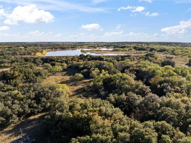 an aerial view of residential building with ocean view in back