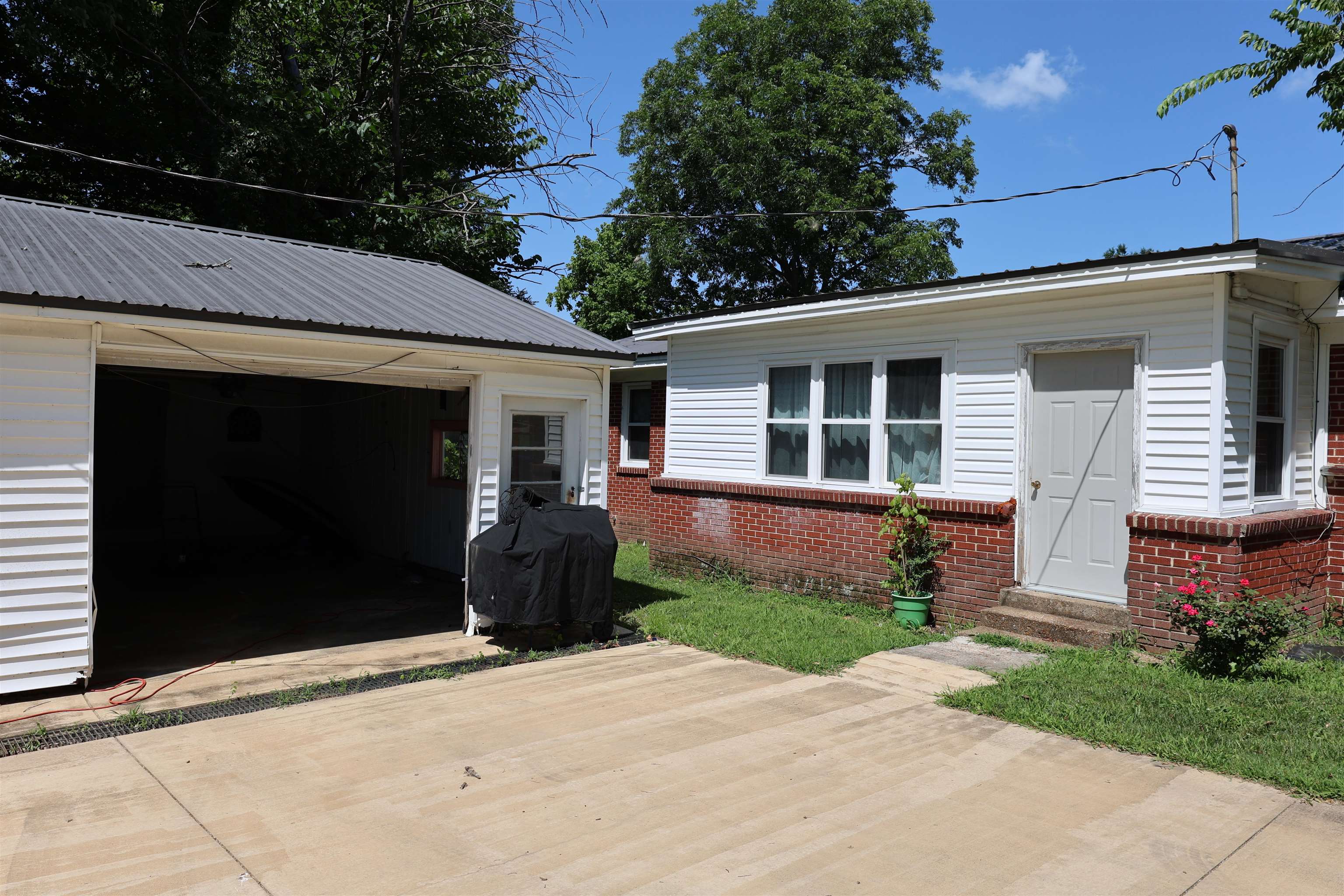 123 North Magnolia Street Adamsville, TN 38310 - Photo 7 of 25 a front view of a house with a garden