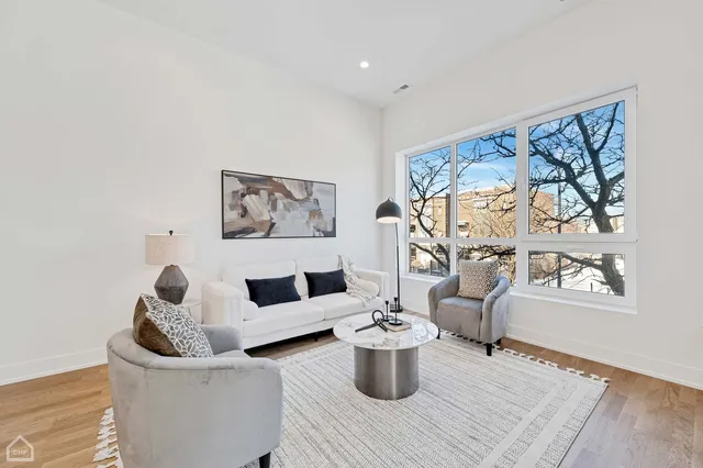 a living room with furniture and a painting on the wall