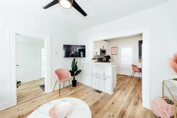 a kitchen with stainless steel appliances a refrigerator and a wooden floor