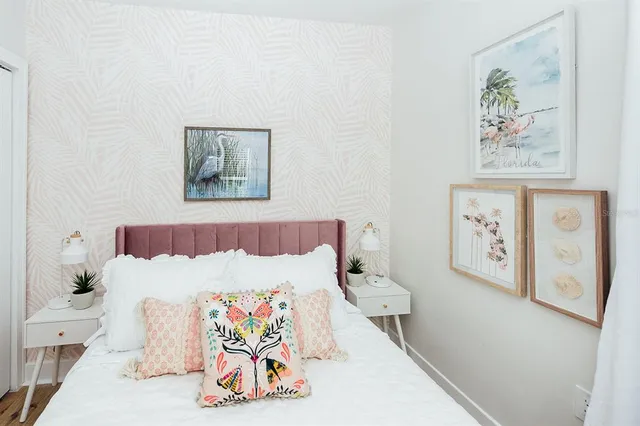 a bedroom with a bed and a flat tv screen