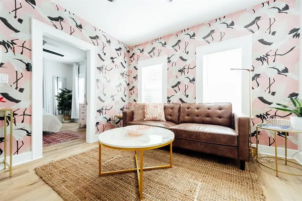 a living room with furniture and wooden floor