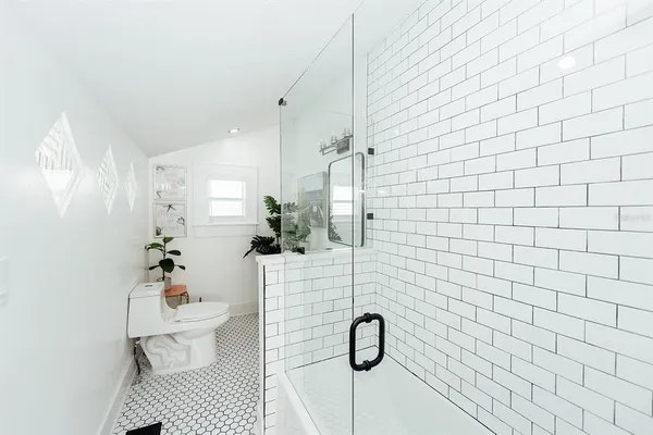 a bathroom with a sink mirror and vanity