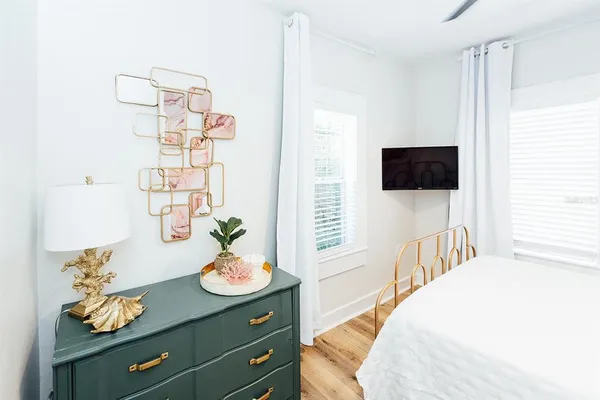 a bedroom with a bed and a flat screen tv