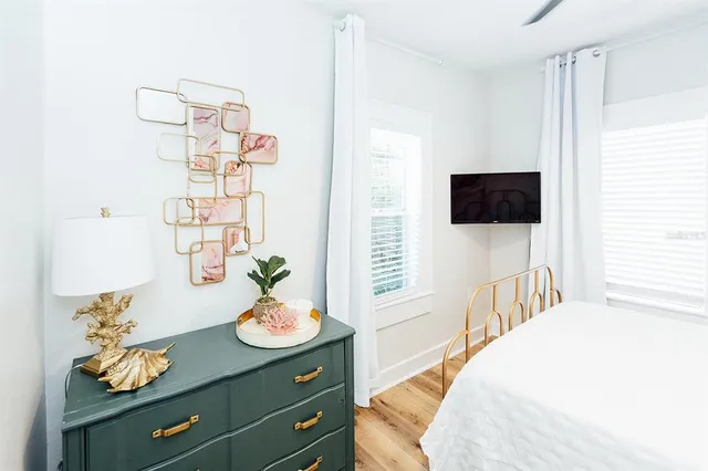 a bedroom with a bed and a flat screen tv