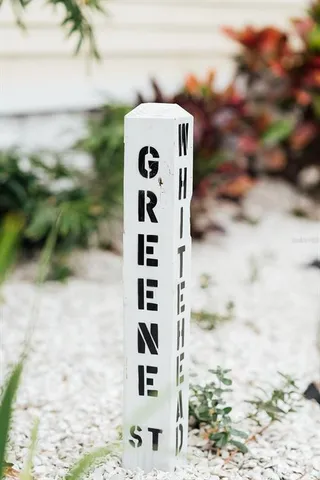 a view of a chair and table in backyard of the house