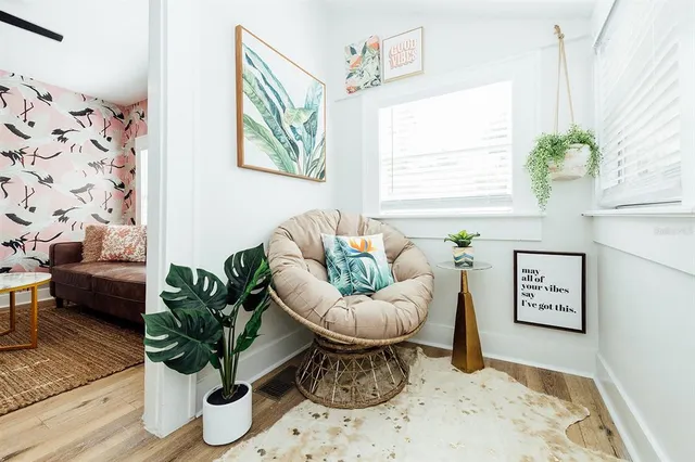 a living room with furniture and kitchen view