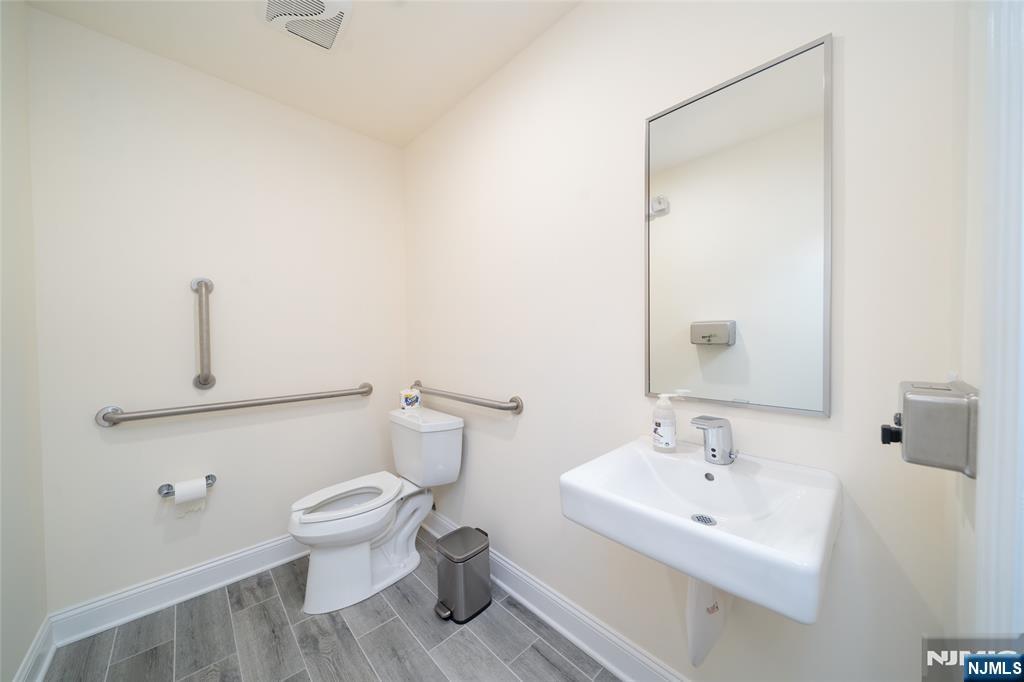 26 Orange Road Montclair, NJ 07042 - Photo 11 of 45 a bathroom with a toilet sink and mirror