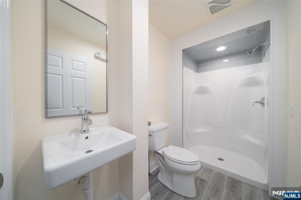 26 Orange Road Montclair, NJ 07042 - Photo 15 of 45 a bathroom with a toilet sink shower and mirror