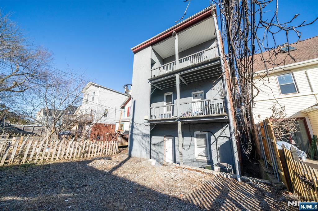 26 Orange Road Montclair, NJ 07042 - Photo 18 of 45 a view of a house with a small yard and wooden fence