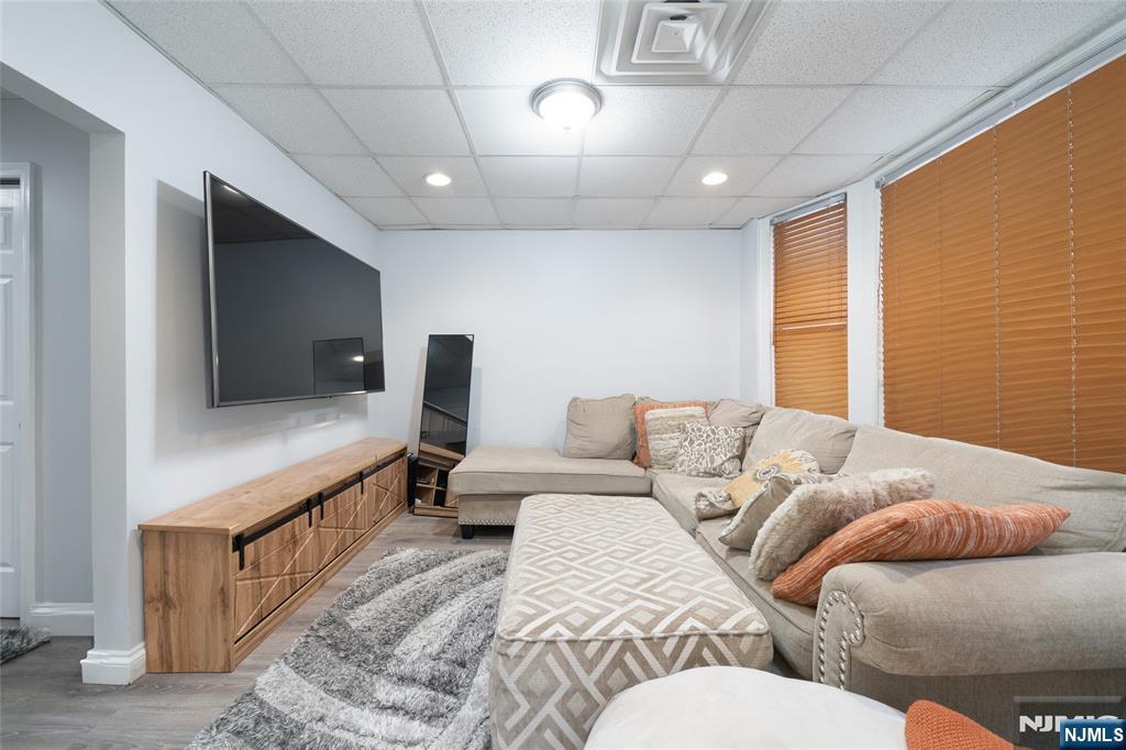26 Orange Road Montclair, NJ 07042 - Photo 20 of 45 a living room with furniture and a flat screen tv