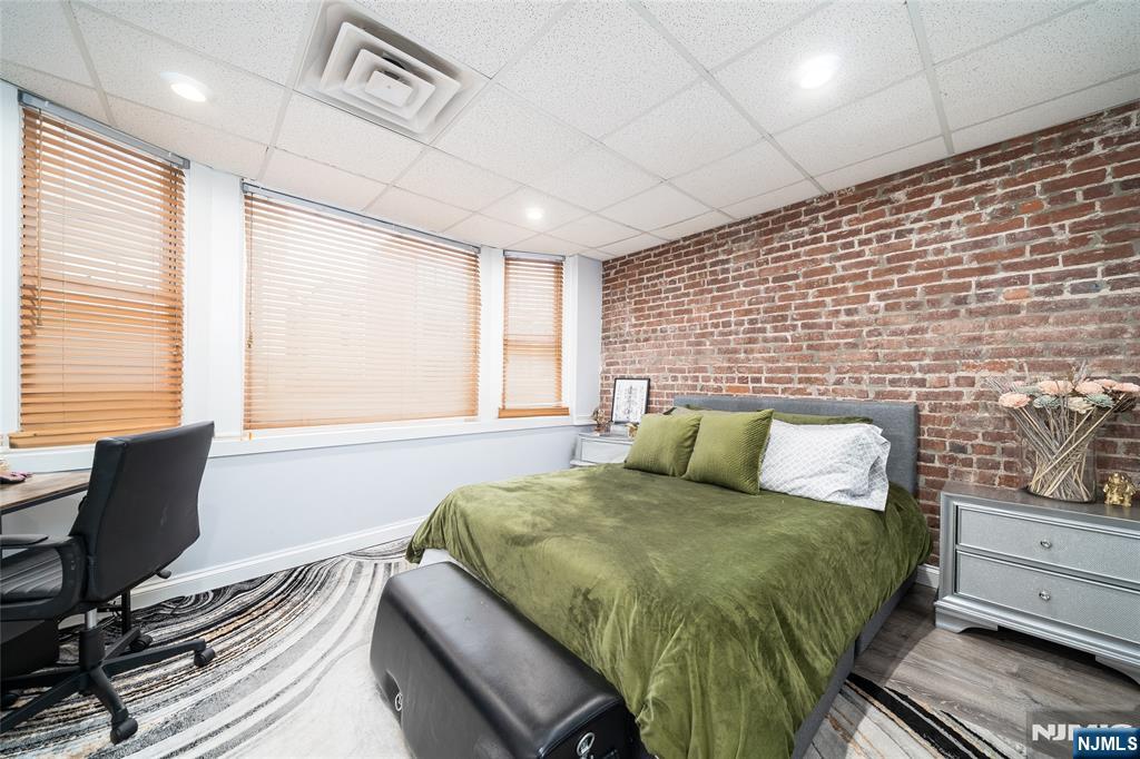 26 Orange Road Montclair, NJ 07042 - Photo 21 of 45 a bedroom with a bed and wooden floor