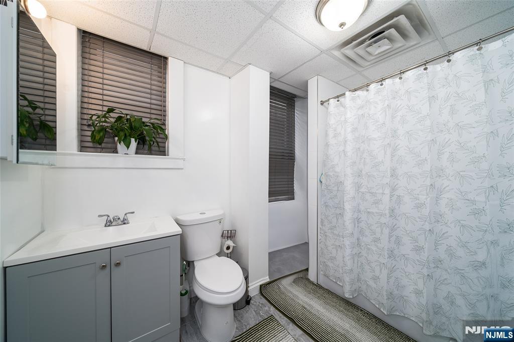 26 Orange Road Montclair, NJ 07042 - Photo 24 of 45 a bathroom with a sink a toilet and shower curtain